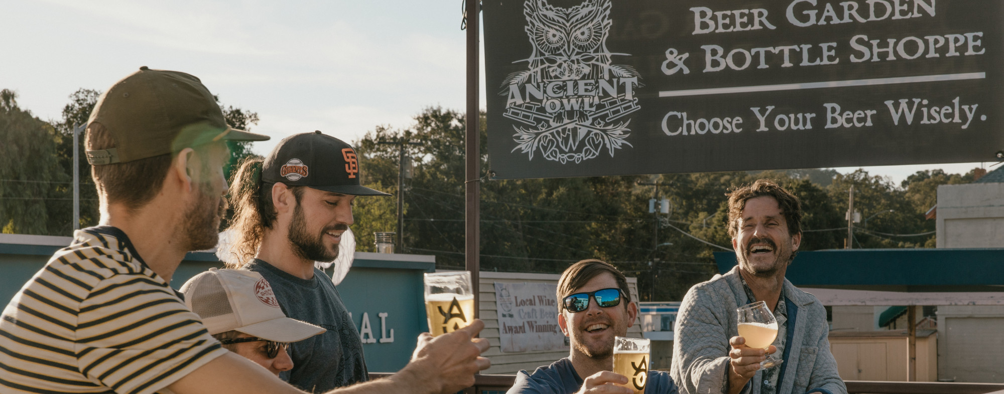 Friends drinking beer at Ancient Owl Beer Garden