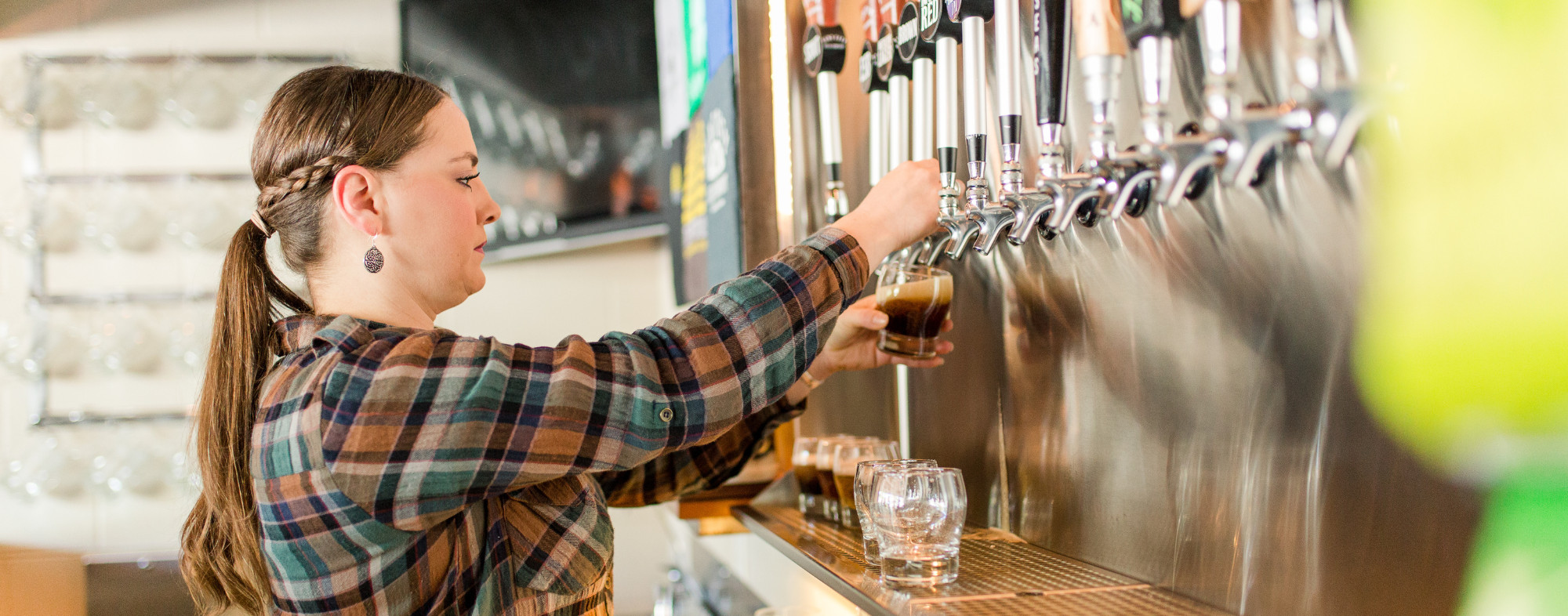 A bartender pouring beer at Tent City