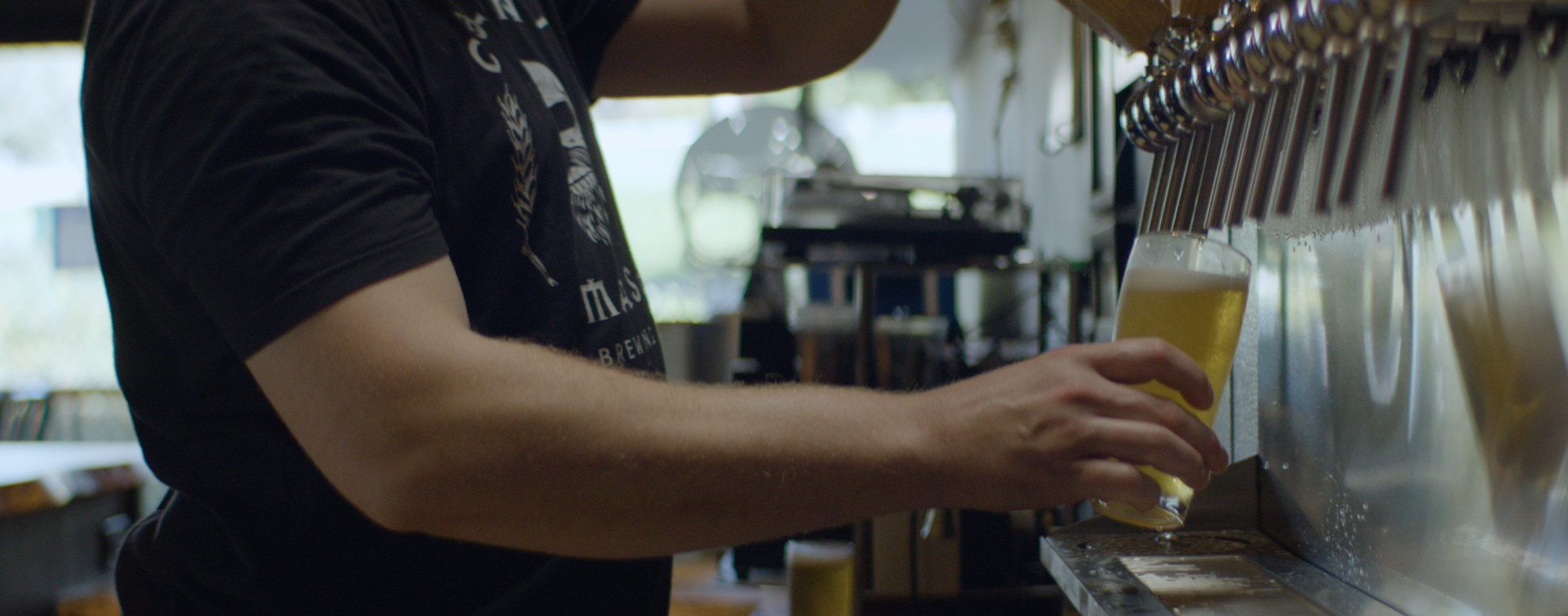 An Atascadero bartender pouring a beer