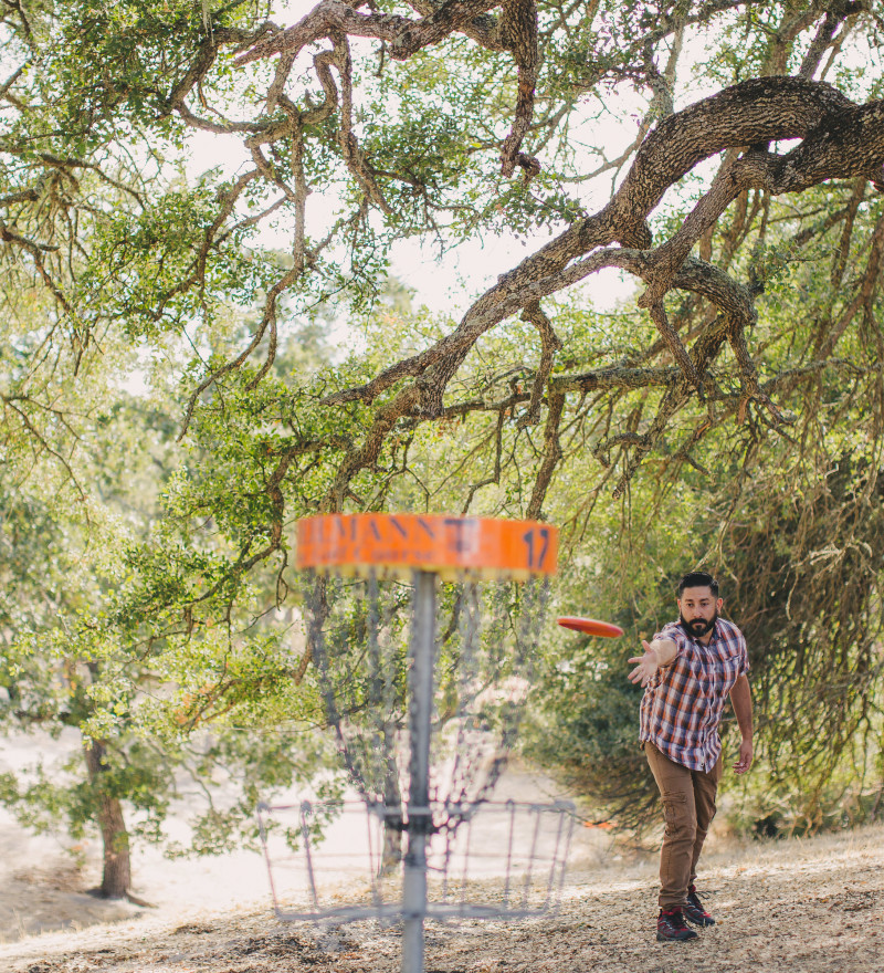 A man playing disc golf at Heilmann Park in Atascadero
