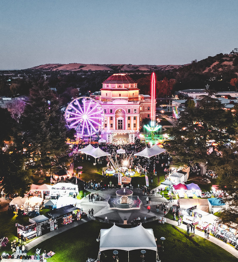 Tents, a stage and carnival rides fill the Sunken Gardens in Atascadero for the Fall Festival