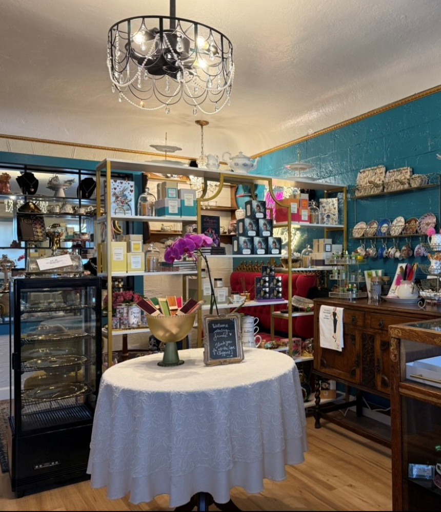 Interior view of The Tea Trolly shop featuring a variety of colorful plates and unique gift items on display.