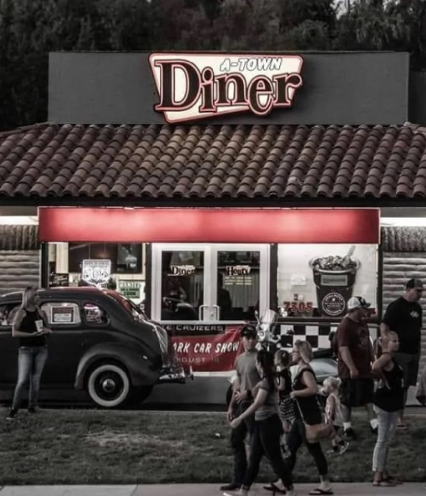 people walking in front of diner