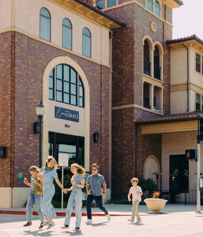 Family walking downtown Atascadero in front of Ernest Grace