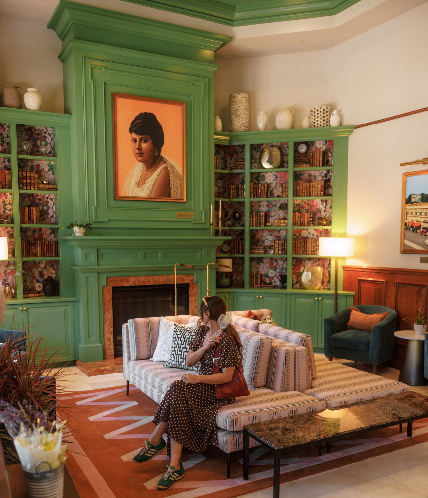 A woman in the lobby of The Carlton Hotel in Atascadero, CA